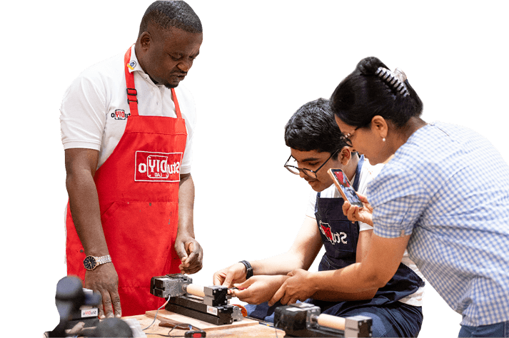 Teacher helping students with woodworking